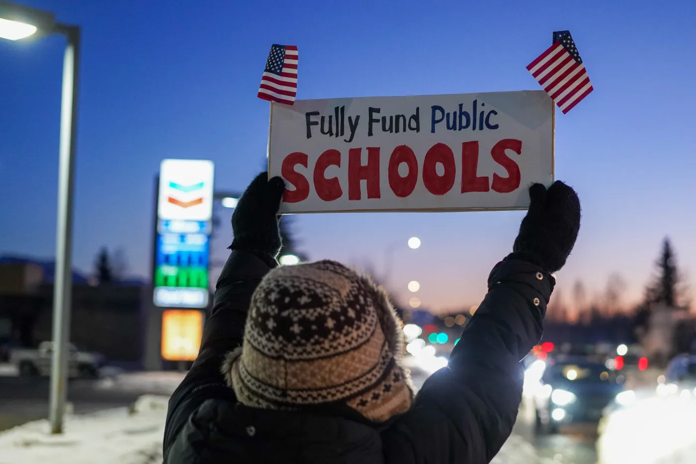 A woman holding a sign saying "Fully Fund Public Schools"