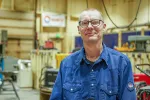 Pete Daley Poses in his welding shop at Hutchinson HS