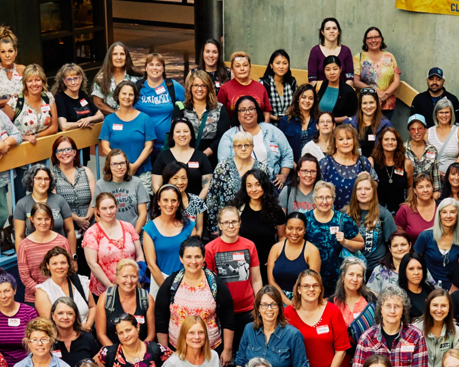 A large group of NEA-Alaska members pose for a picture in a school.