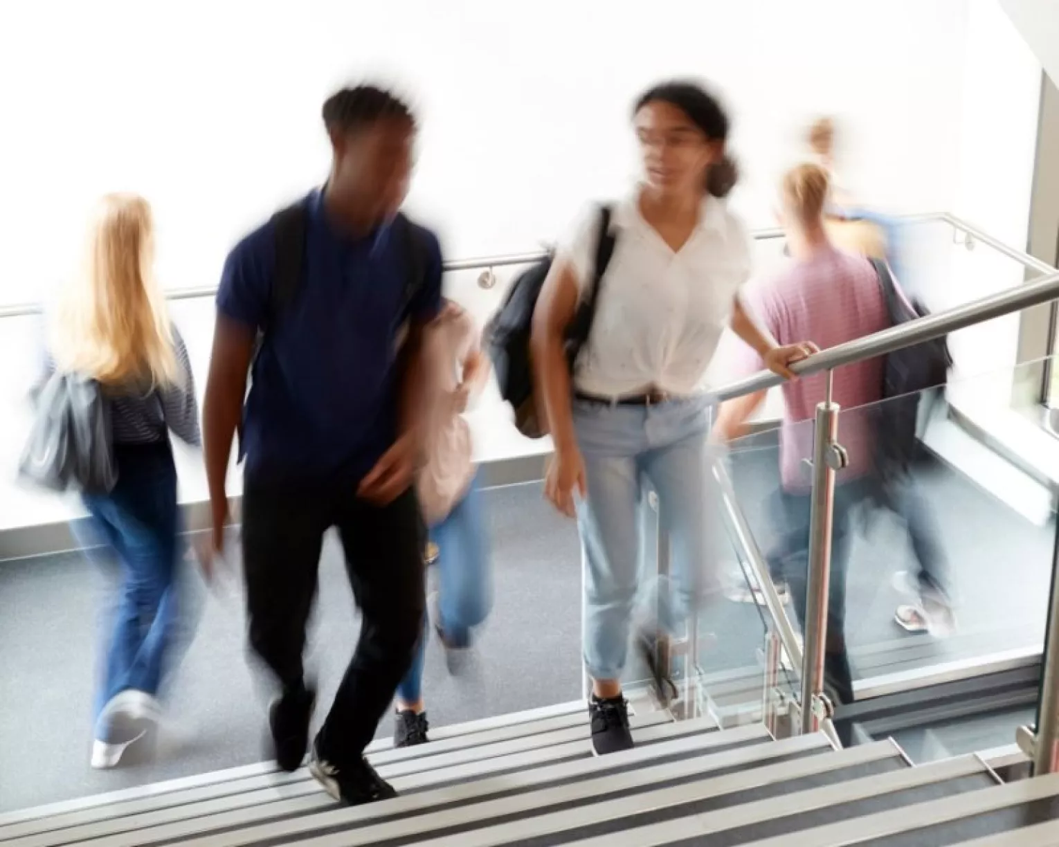a blurry photo of students walking up stairs