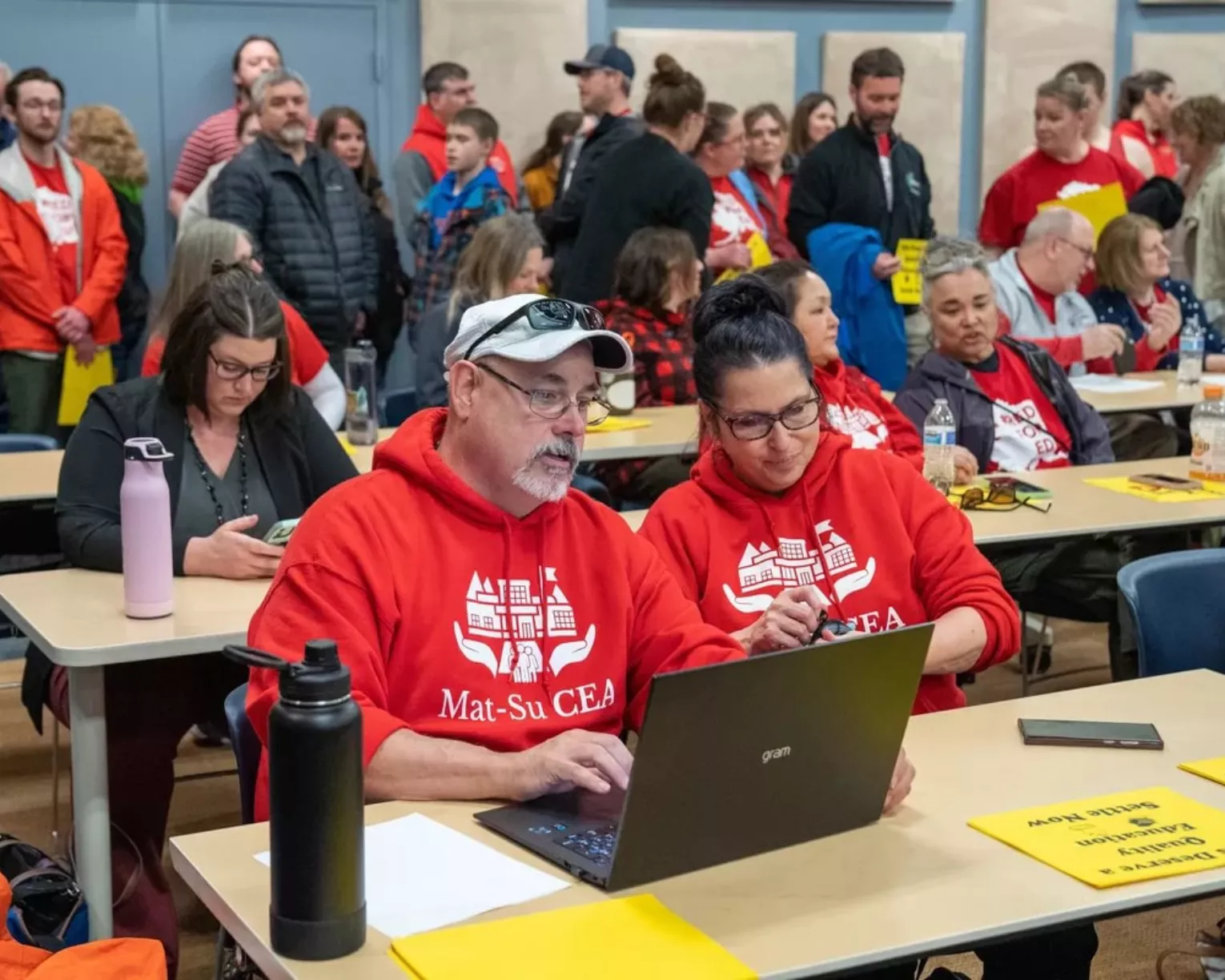 Mat-Su Classified Employees' Association members look at a lap top with interested expressions