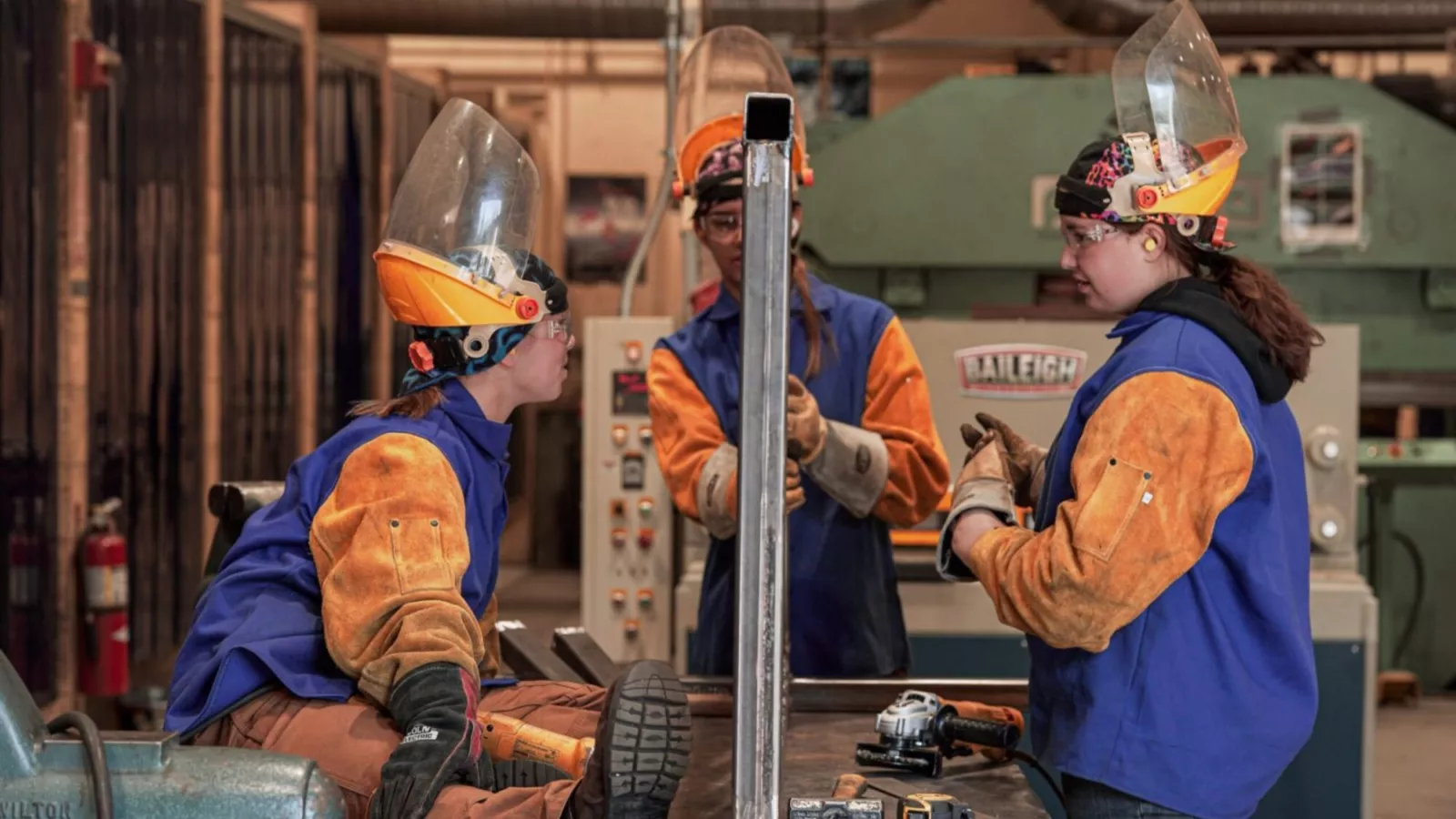 Peter Daley's students work in the classroom with safety equipment on.