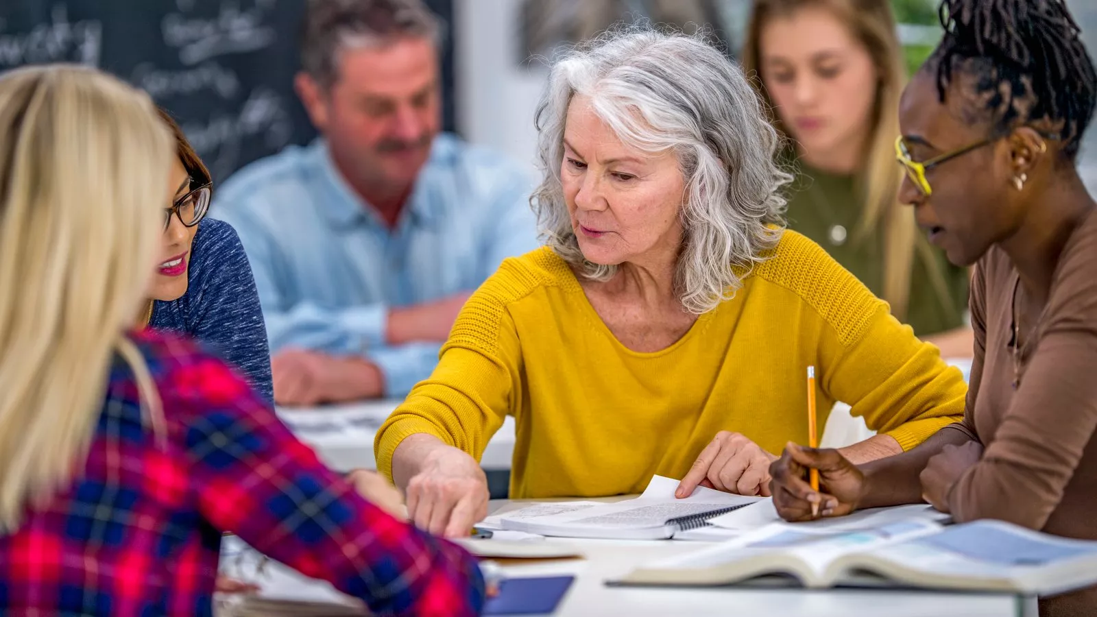 Educators in a professional development work together at a table.