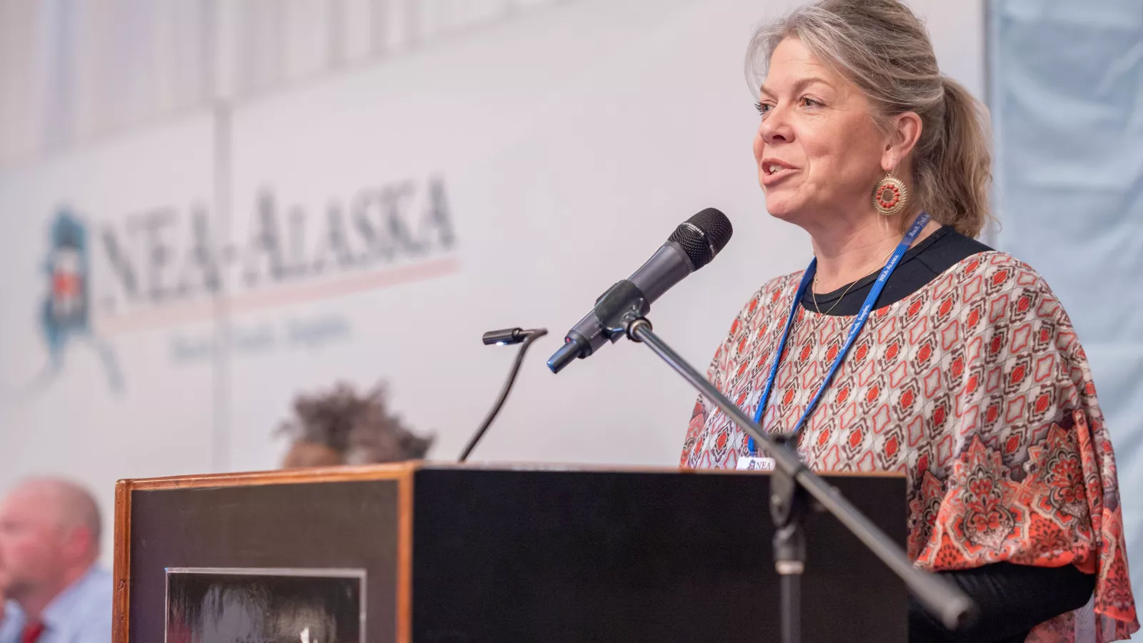 A member at the microphone giving her awards acceptance speech at Delegate Assembly