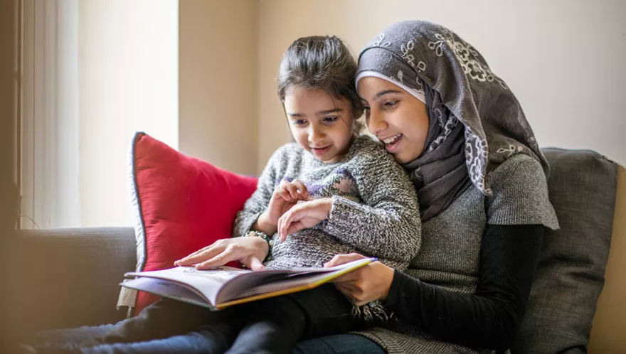 Big sister reads to her little sister