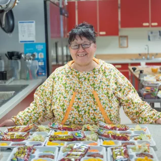 Phyllis Clough posing with her school lunches.