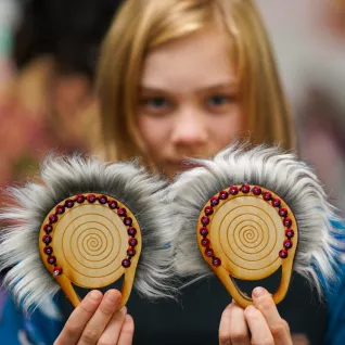 A student shows off her traditional native american dance fans.