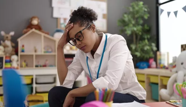 a stressed teacher in her classroom