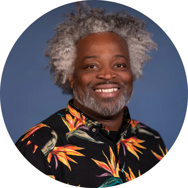 A portrait of a dark-skinned gentleman with salt and pepper hair
