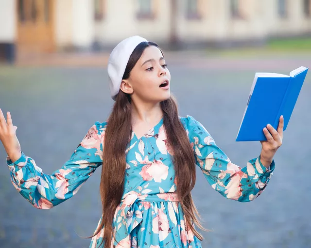 girl reading poetry out load in the community