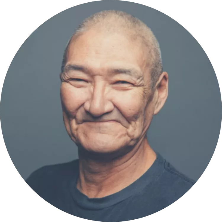 Samuel Jackson smiles for a portrait. You cannot see their teeth. Their eyes are crinkling with joy.