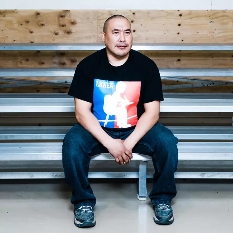 Glenn Charlie sitting on bleachers