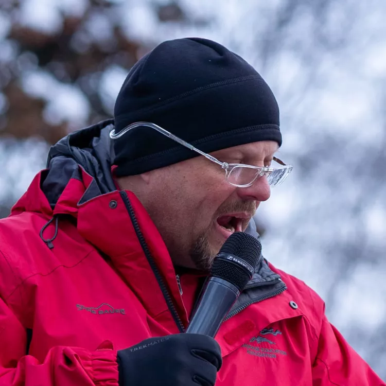 Tom Klaameyer speaks into a microphone at the Raise the BSA rally.