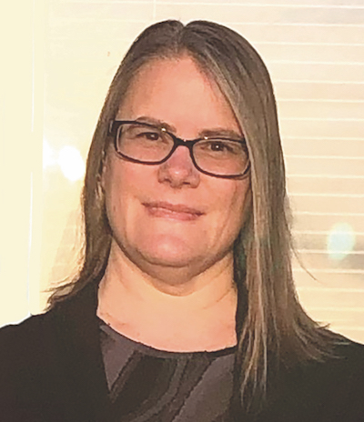 Teacher Danielle Specht from Alaska smiles wearing black top and glasses.